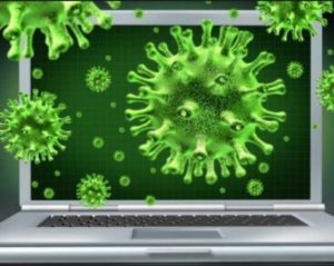 An open laptop with large green virus particles bursting out of and crawling across its screen.