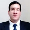 Headshot of a man in a suit and tie, the subject of the account